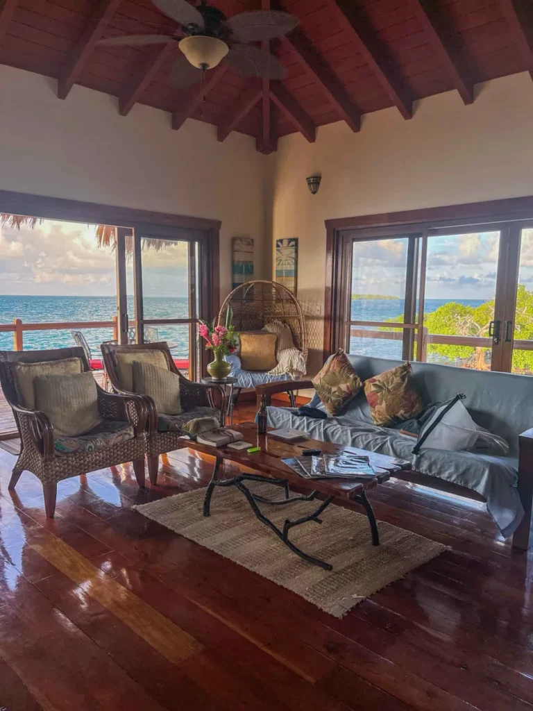 charming wooden interior in a living room at the living area in the over water bungalow at little peter oasis, a private island rental in belize 
