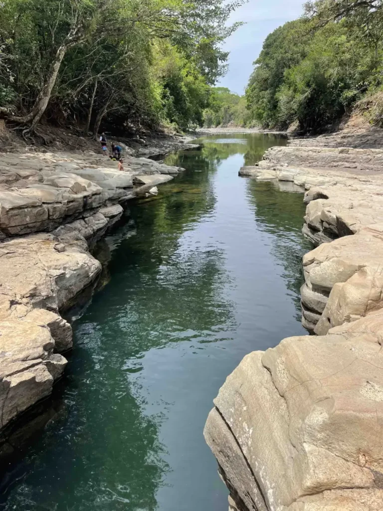 river flowing through a rocky canyon with lush jungle vegetation around in panama