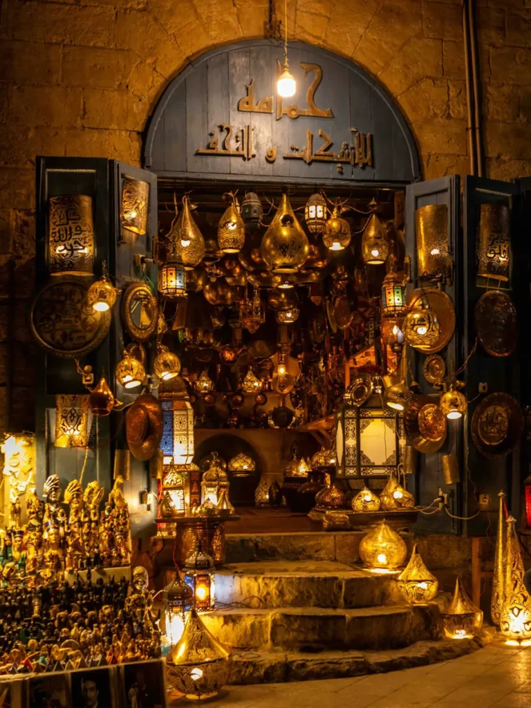 an open shop with numerous illuminated lanterns in the shop and on the stairs