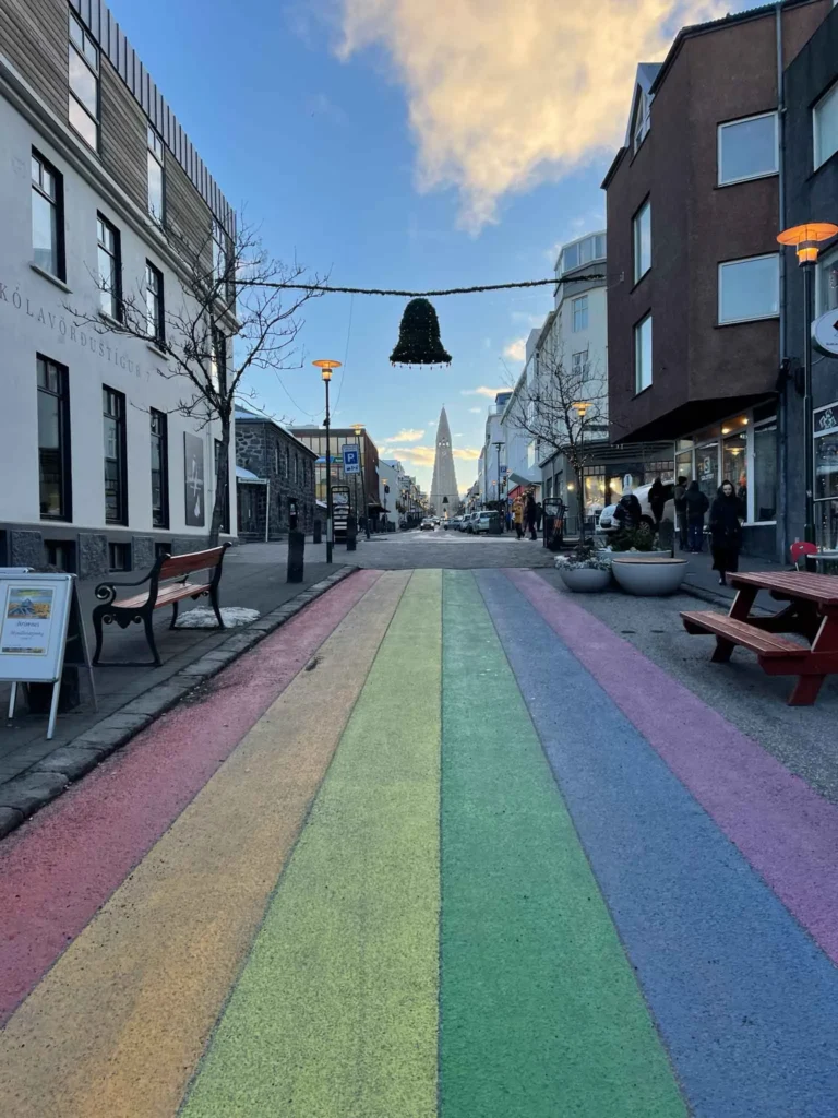 painted rainbow on a street in reykjavik in iceland with buildings on the side