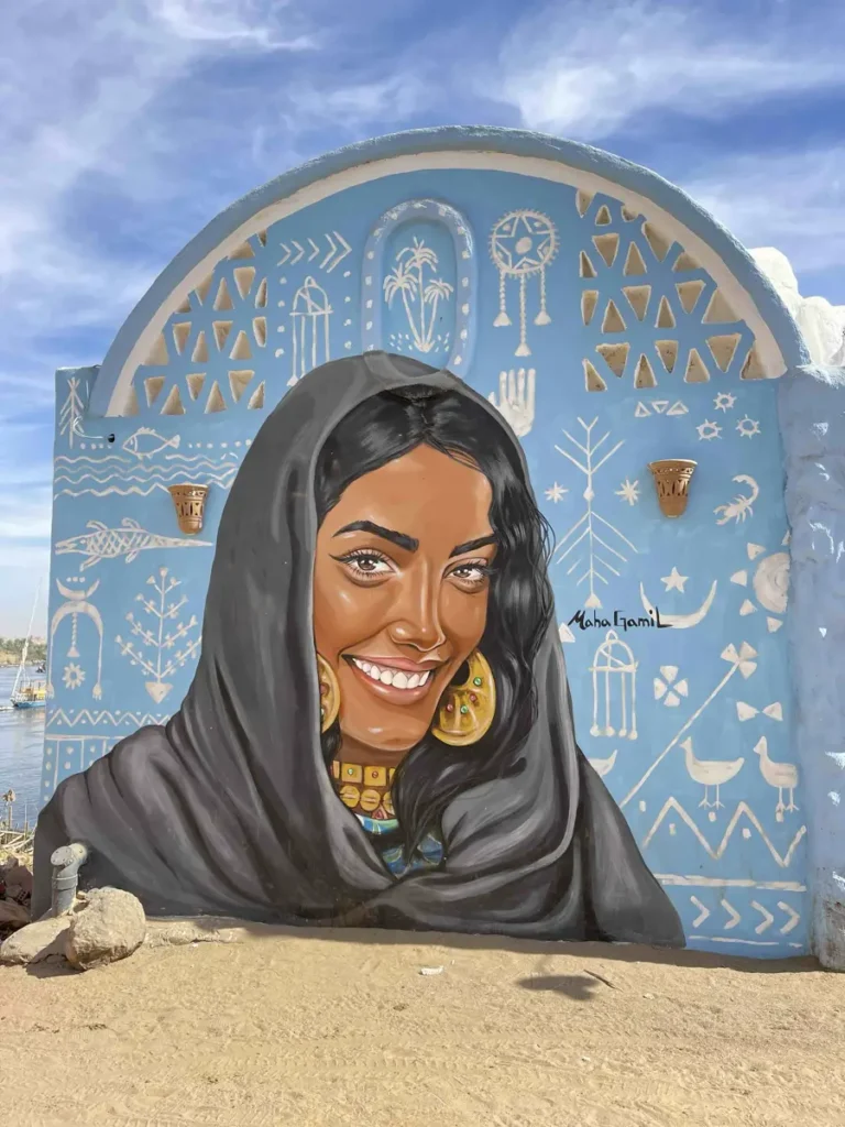 image of a woman painted on the side of a colourful round house