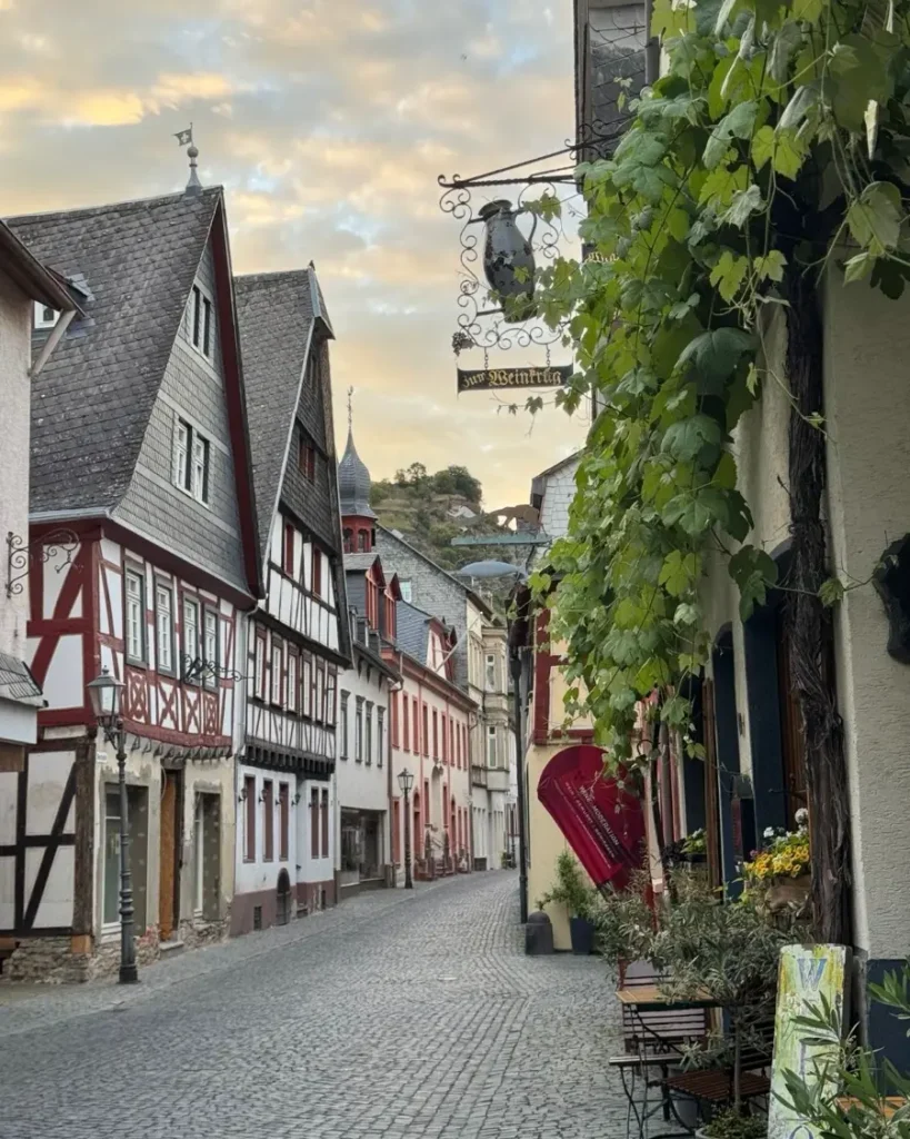 Charming medieval storybook town with cobblestone roads, vine, half-timbered houses during sunset in Bacharach, Germany
