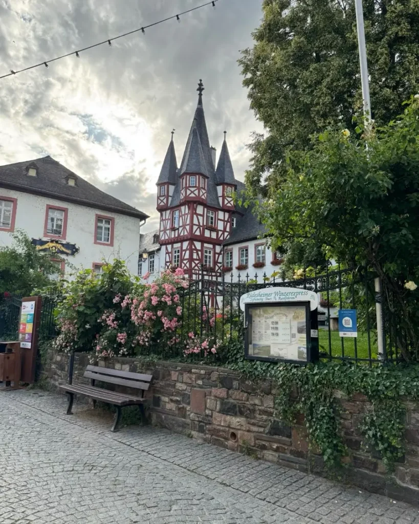 Charming old town of the fairytale town of Rüdesheim am Rhein with a traditional half-timbered tower, houses and greenery