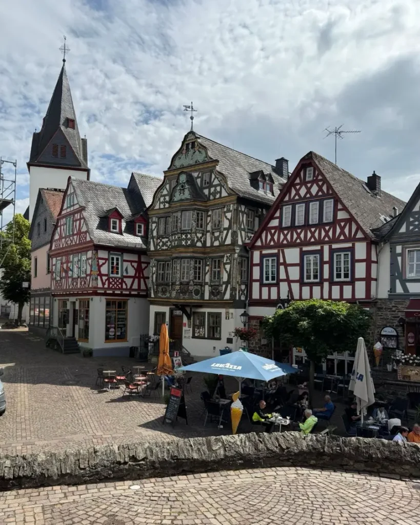 Traditional half-timbered houses, a church and outdoor seating area on the main square in Idstein, Germany