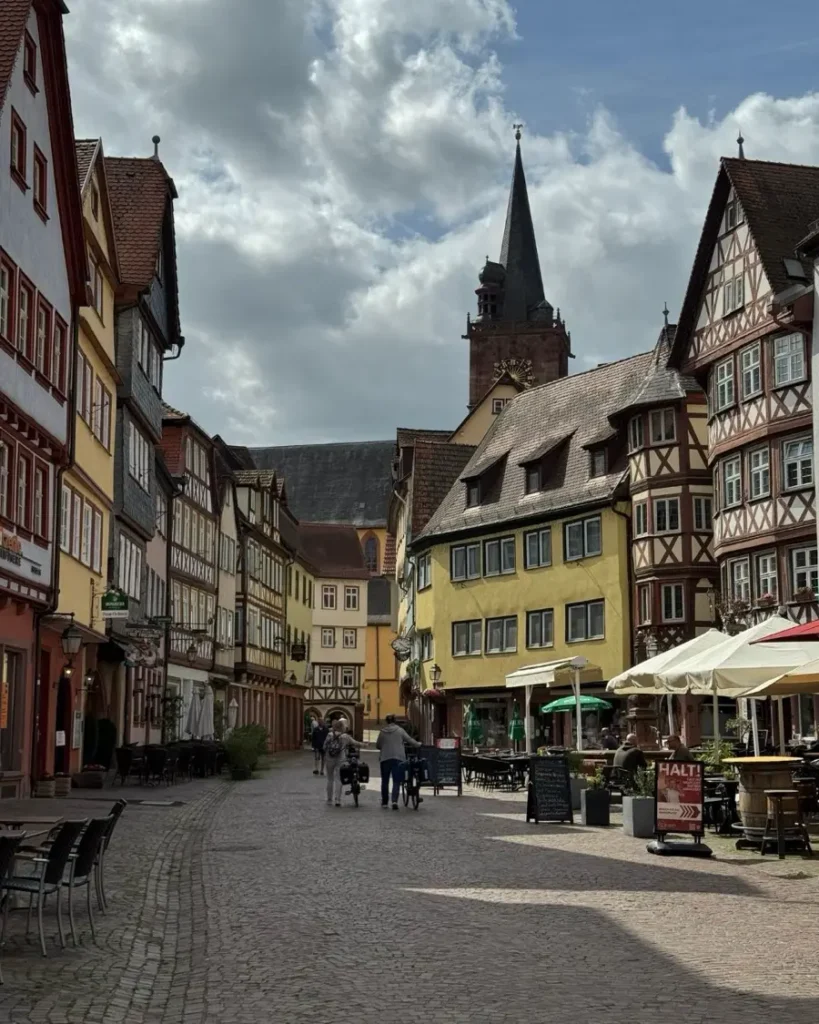 Colourful old town road with cobblestones leading to a church in the fairytale town of Wertheim am Main in Germany