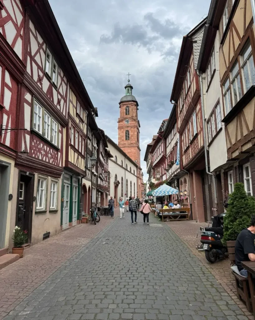 Cobblestone roads filled with half-timbered houses leading to a church in the medieval storybook town of Miltenberg