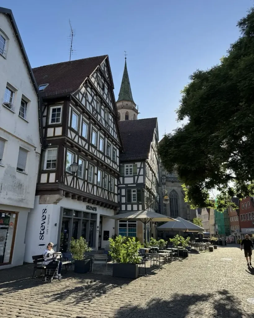 Traditional town in Germany with a church tower, cobblestone roads, half-timbered houses and trees in Schorndorf
