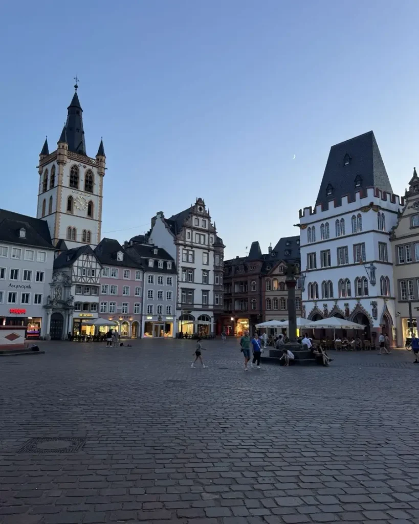 Charming old town with beautiful houses and a church tower during blue hour in the oldest city in Germany - Trier