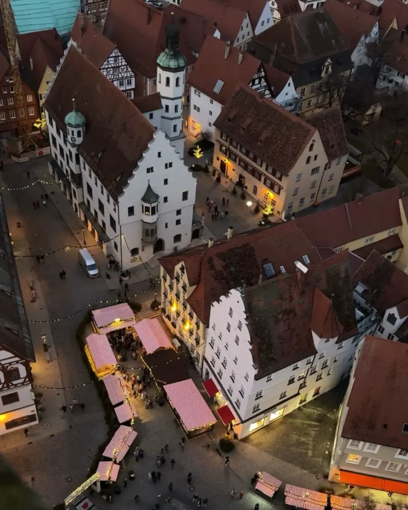 bird's eye view of a historic town center during Christmas time with market stalls, Christmas lights and traditional buildings in Nördlingen, Germany