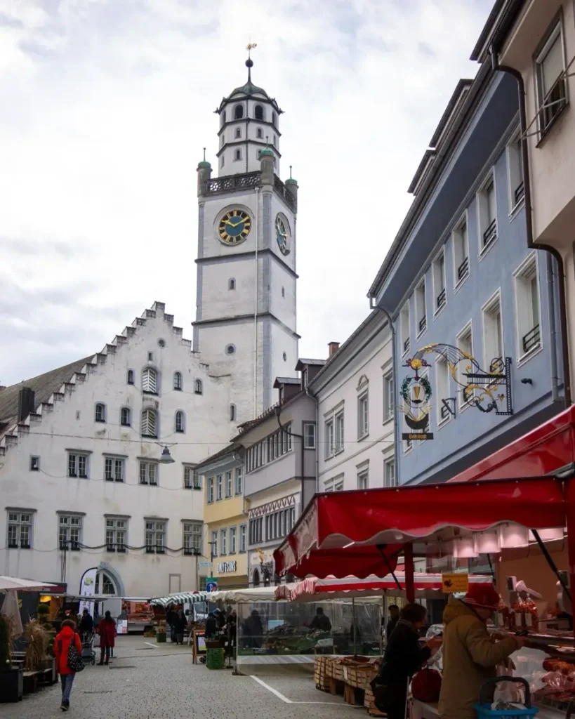 Old town road with a view of the Blaserturm, colourful houses and market stands in Ravensburg, Germany