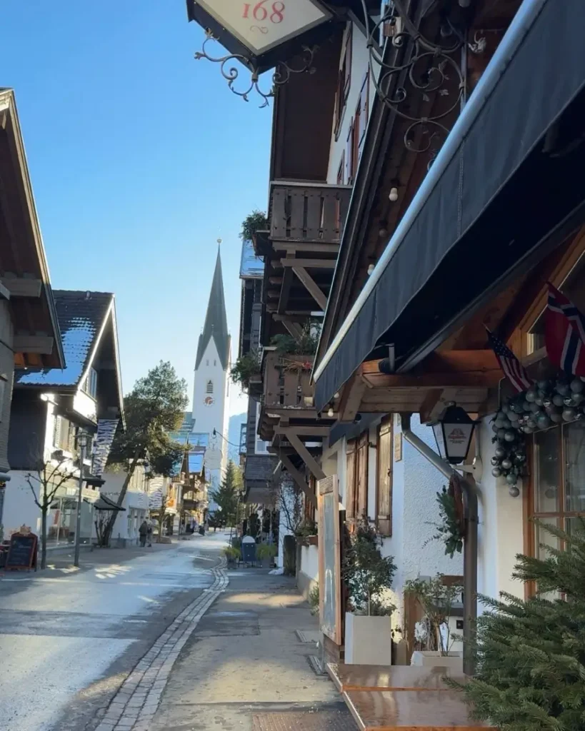 Traditional mountain town in Southern Germany with a church and partly wooden houses with decorations in Oberstdorf - Germany