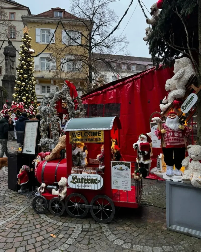 Christmas decorations with a Christmas tree, a small red train and teddy bears in the old own of Baden-Baden, Germany