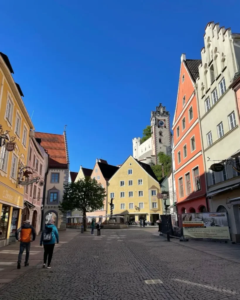 Old town with colourful houses, a pedestrian zone and a castle in the end of thr street in Füssen, Germany
