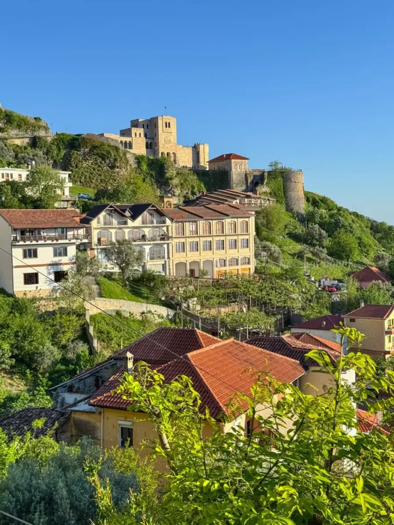 Kruje: a view from town of a hillside with a castle, some houses and greenery - not to miss on your Albania roadtrip