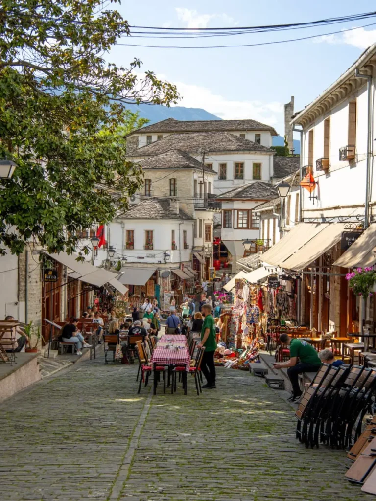 Street view of Gjirokastër, Albania a town with traditional white houses with stone roofs in Ottoman architecture