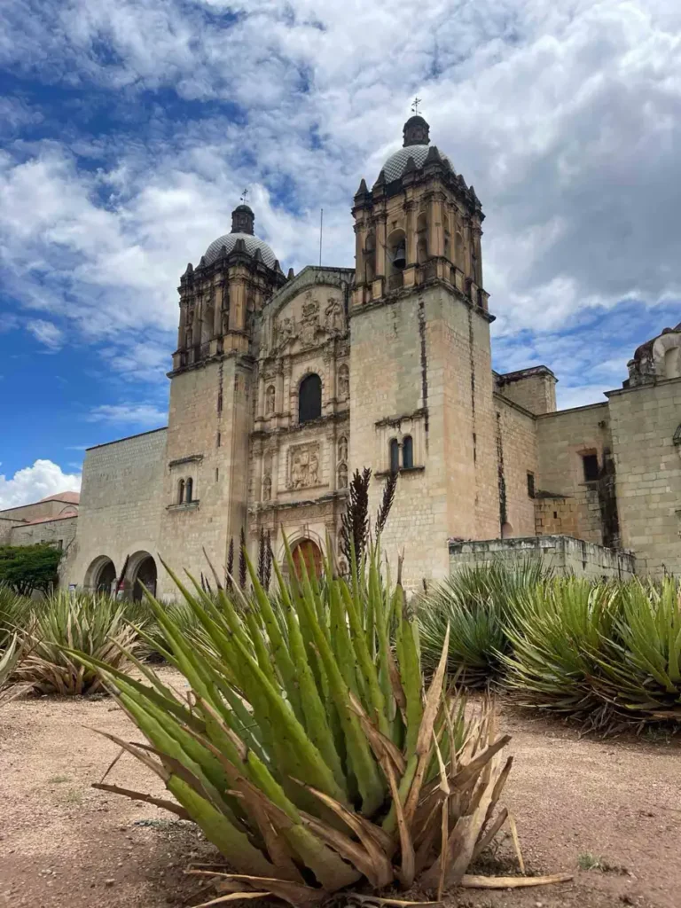 beautfil old building at Plaza Santa domingo in Oaxaca City with many details out of stone with green bushes in the front 
