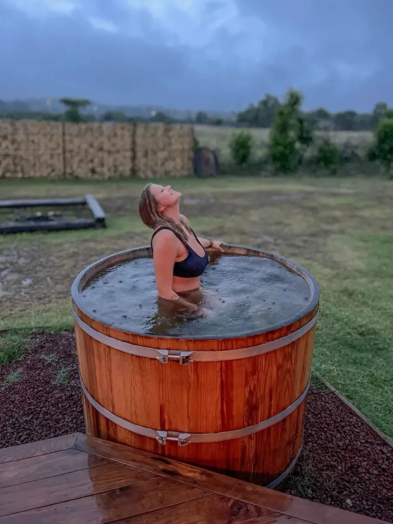 Etlan Cabana in Oaxaca blonde woman in a black bikini sitting in a wooden hot tub at etlan cabanas in mexico near oaxaca city surrounded by mexican nature