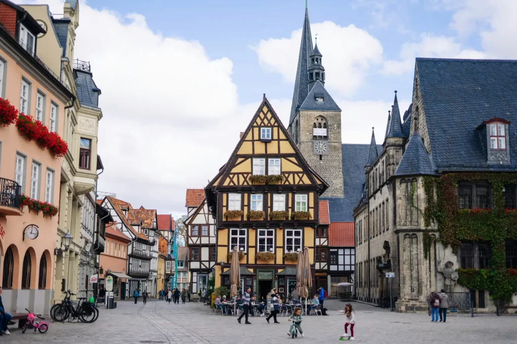 Historic old town with half-timbered houses, a church and some pedestrians in the UNESCO city of Quedlinburg in Germany