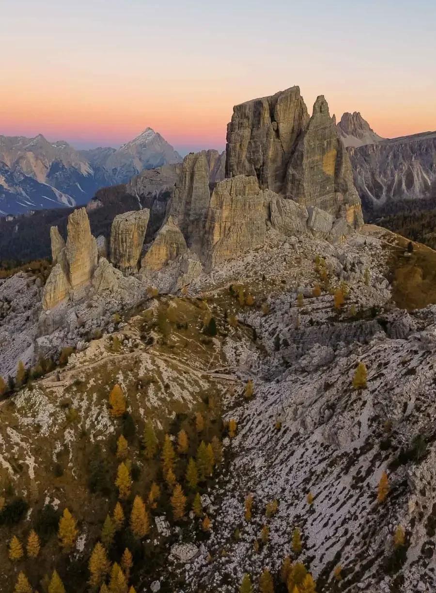 Bird's eye view of majestic rock formations with towering peaks during sunset at Cinque Torri in the Dolomites