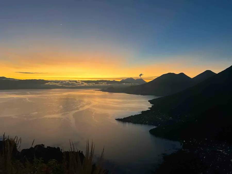 view of lake atitlan and surrounding mountains and volcanoes at indian nose hike at sunrise in guatemala