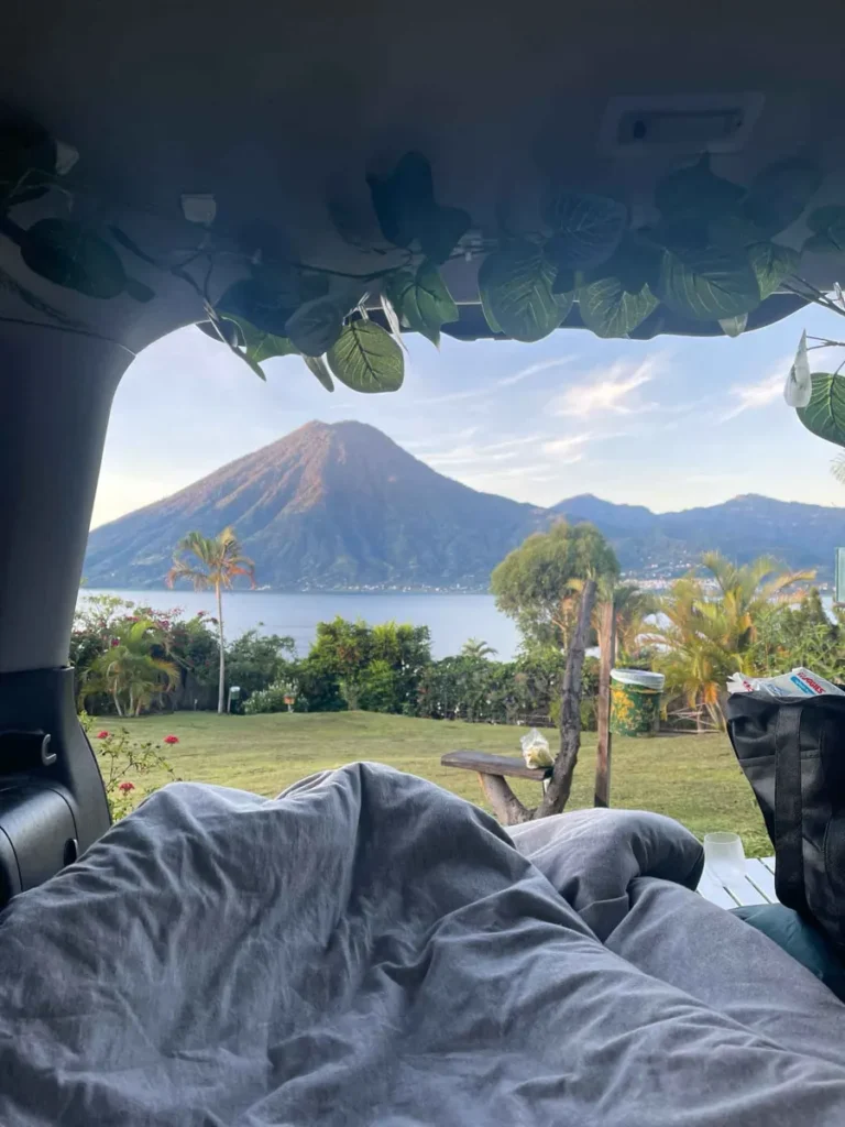 picture from inside the car while car camping at Pasaj Cap in San Marcos at lake atitlan in guatemala with greenery and a view on the lake and volcano