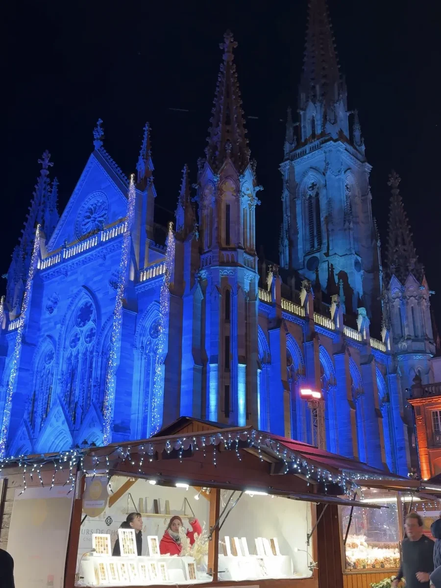 Stalls in front of the Mulhouse Cathedral at one of the most underrated Christmas markets in Alsace