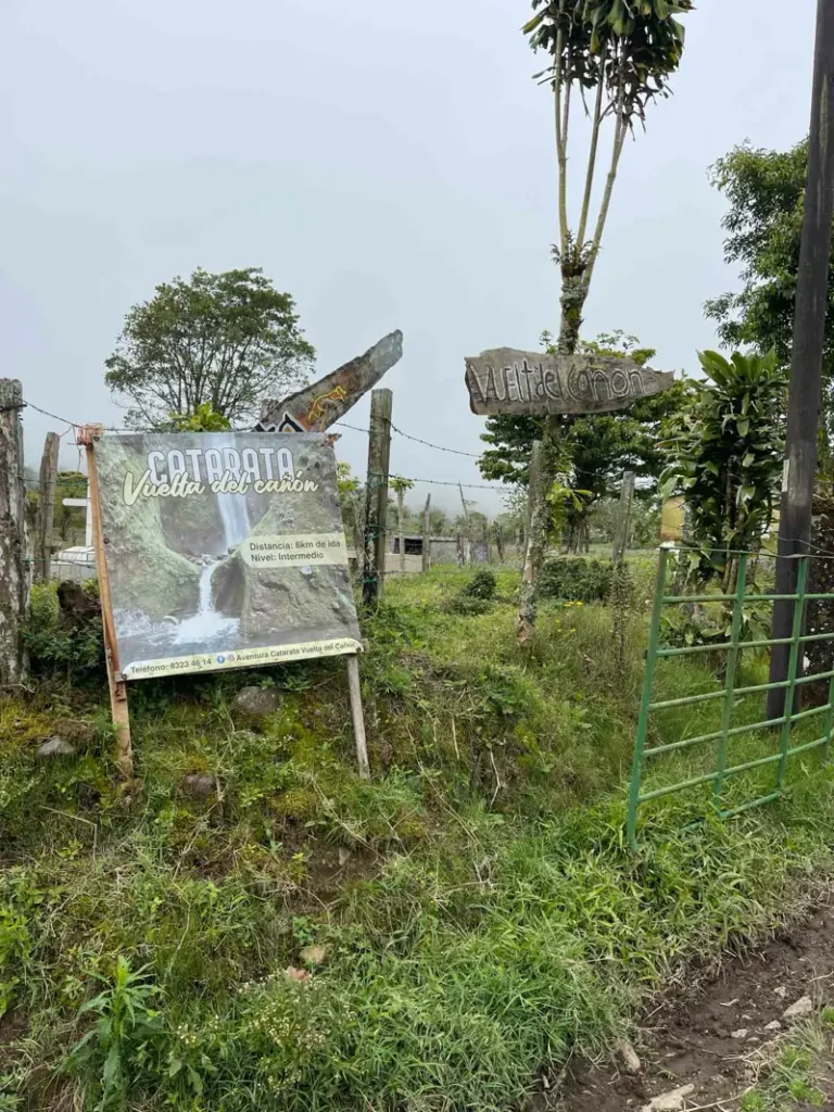 entrance to the cow farm where the trailhead is with a sign of catarata vuelta del canon on bajos del toro in costa rica