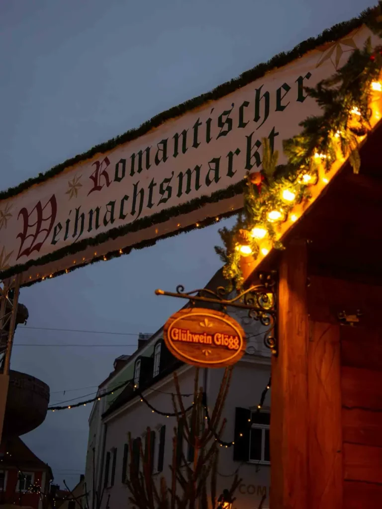 Large sign between Christmas market stalls at the Romantic Christmas market in Nörlingen, Germany