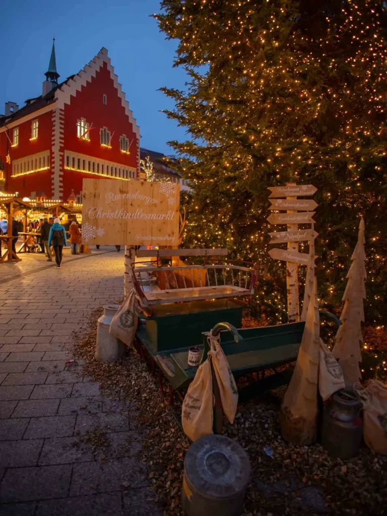 Christmas decorations, stalls and tree in front of a traditional building in Ravensburg, Germany