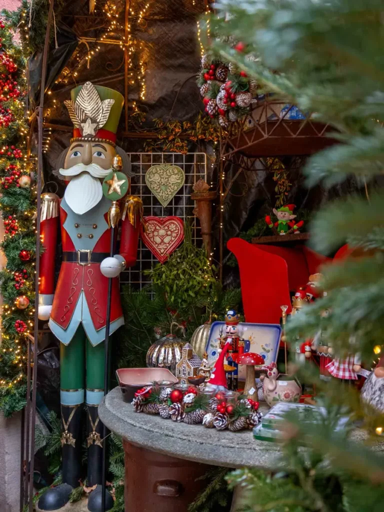 A shop with festive Christmas decorations and Christmas gifts for sale including a large nutcracker statue
