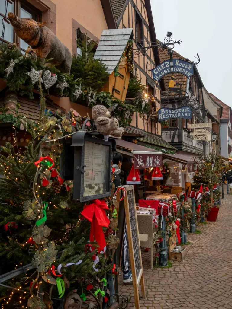 A festively decorated restaurant in a traditional house with christmas hats in Kayserberg-Vignoble
