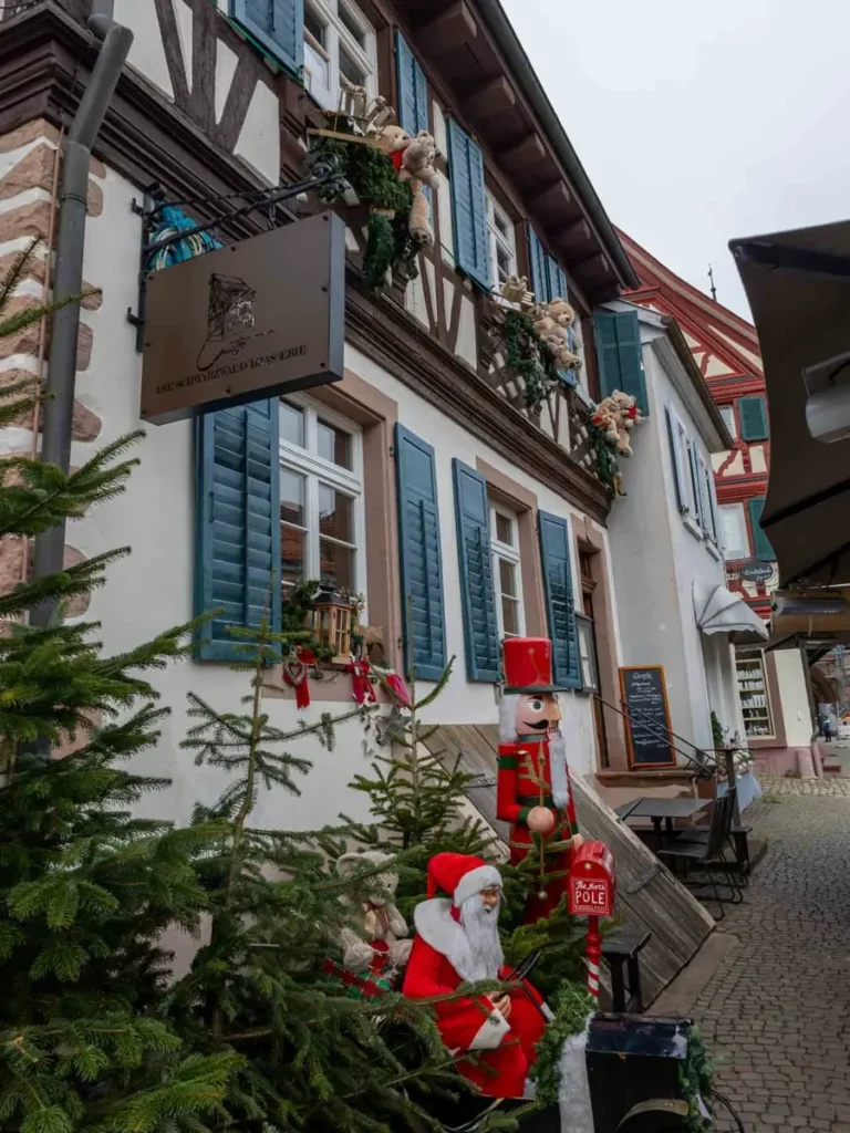 A traditional half-timbered house in Gengenbach with Christmas decorations including teddy bears