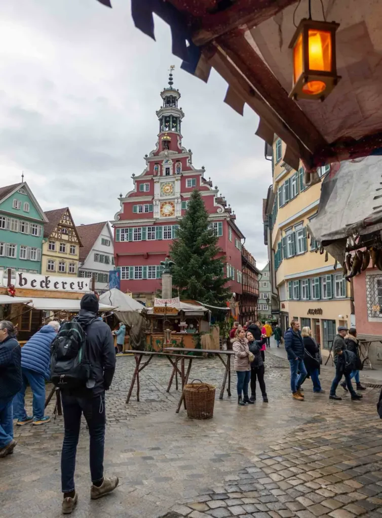 Christmas market in Esslingen, Germany with in front of the red town hall with some stalls and visitors visible